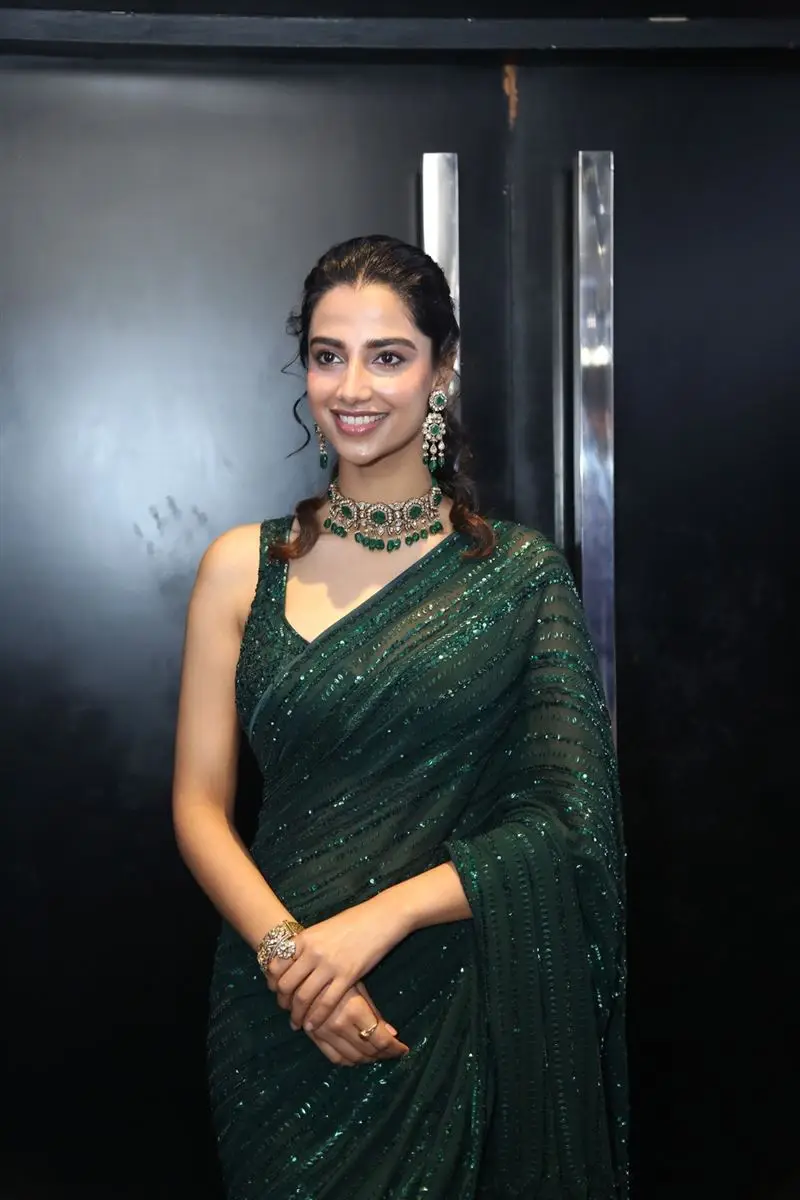 Meenakshi Chaudhary Wearing Beautiful Earrings Jewellery Green Saree